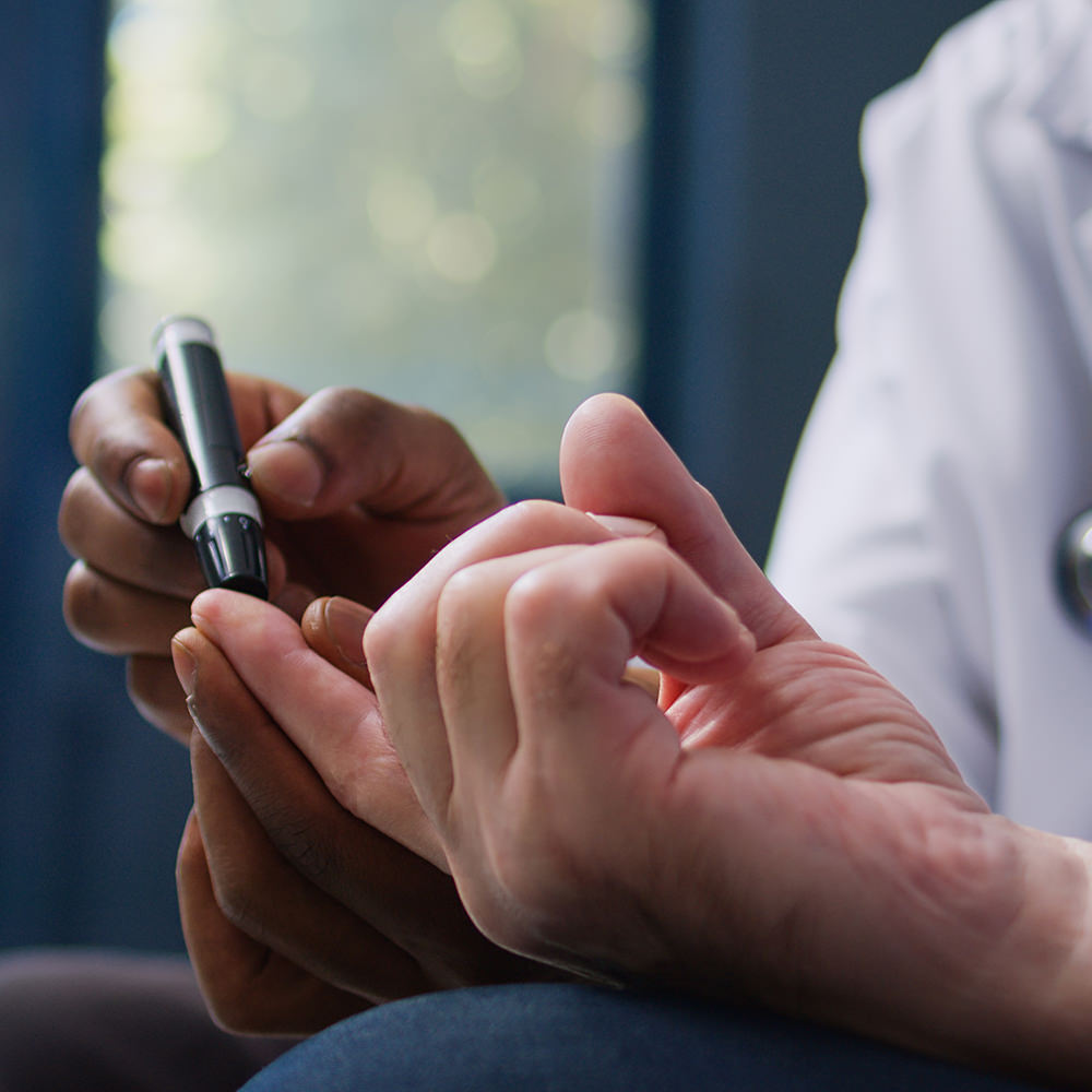 Diabetic patient having a finger prick to check insulin levels.