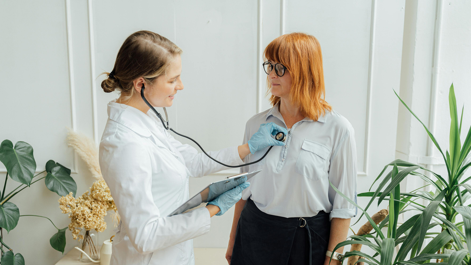 Specialist listening to a patient's breathing using a stethoscope.