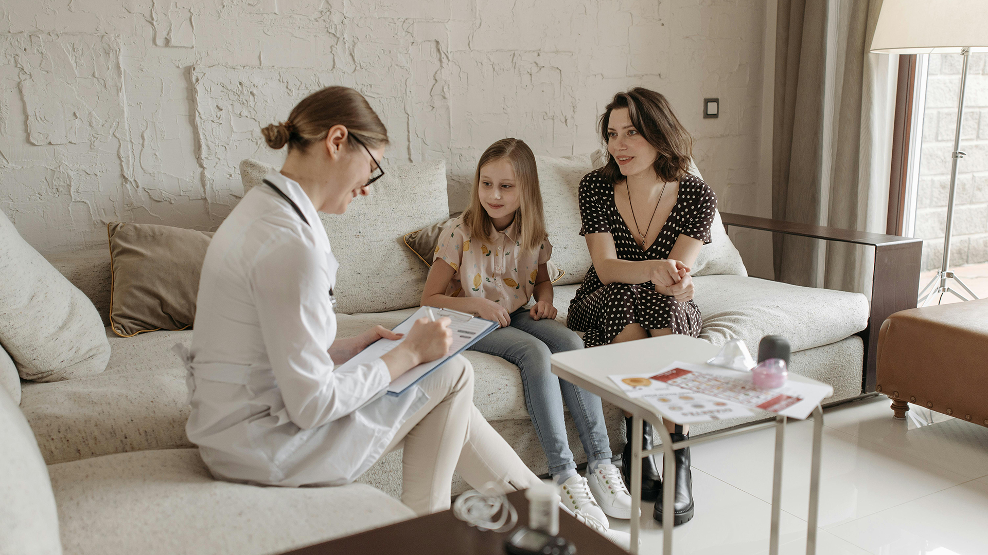 Specialists having a consultation with a mother and her daughter.